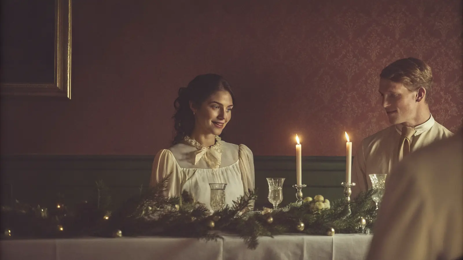 A warm, candlelit December wedding reception with festive touches