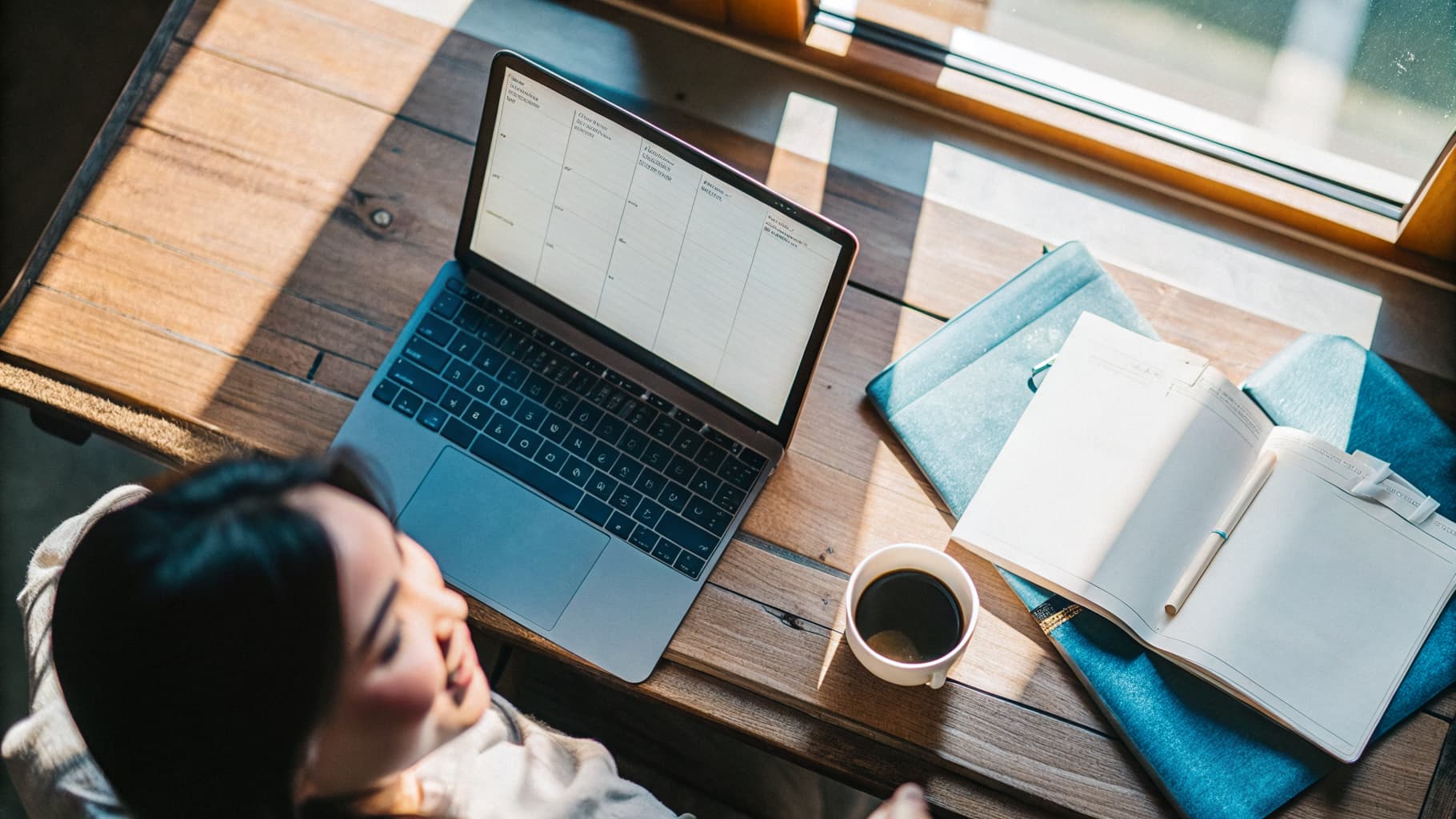 A wedding-business owner at her desk, planning her bookings on a laptop — the business Setnayan is built to grow