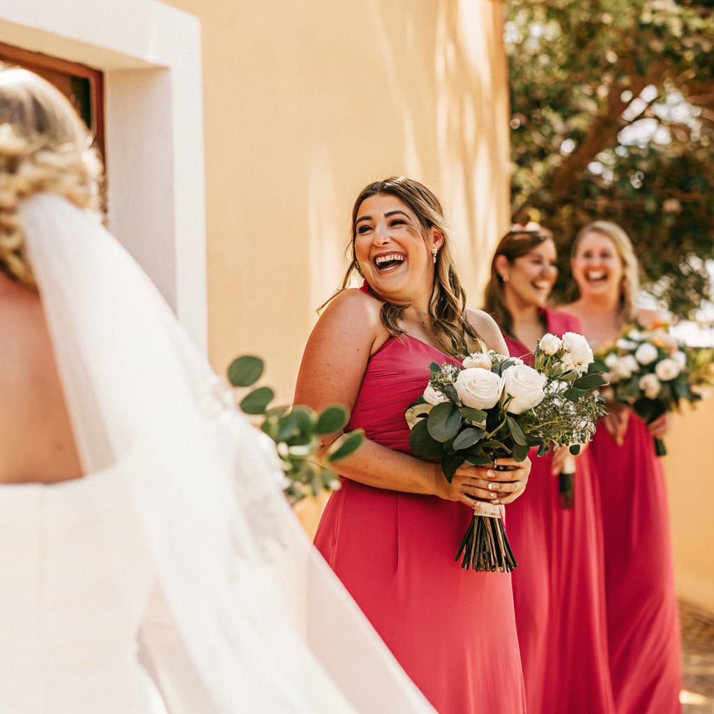 Bridesmaids laughing together with their bouquets